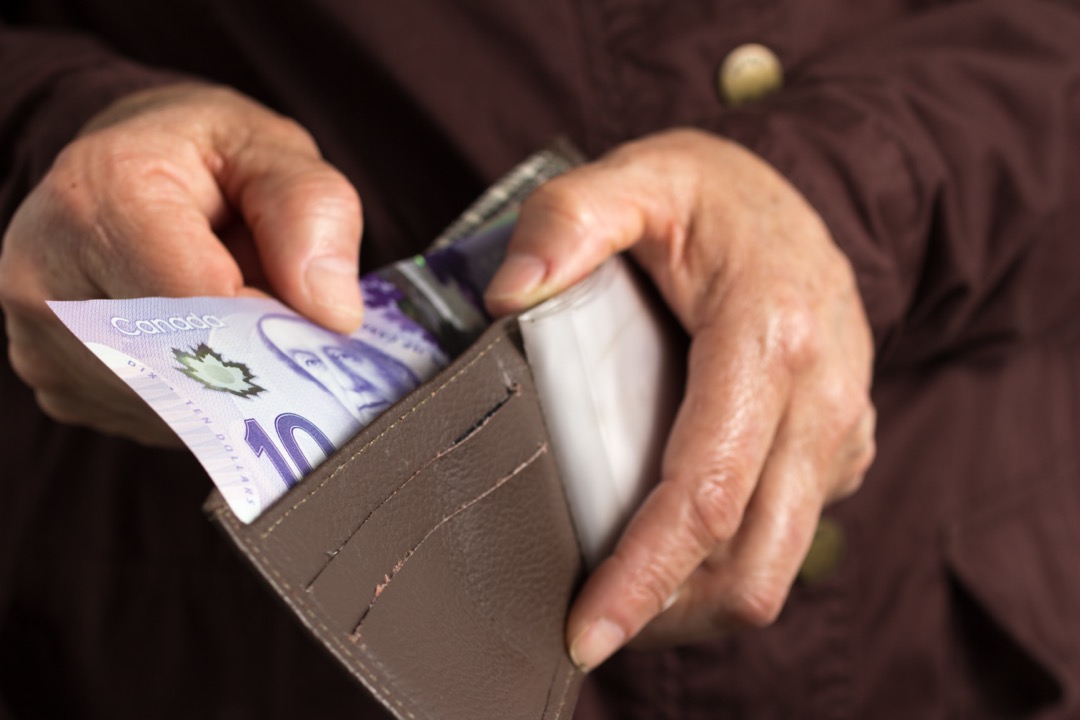 Man putting money in a wallet
